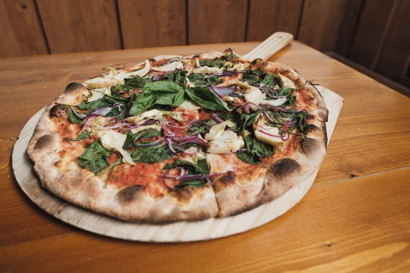 Veggie supreme thin crust pizza with colorful toppings