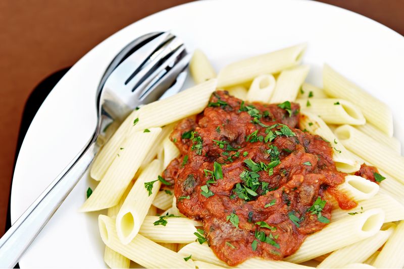 Baked ziti pasta with meat sauce and melted cheese